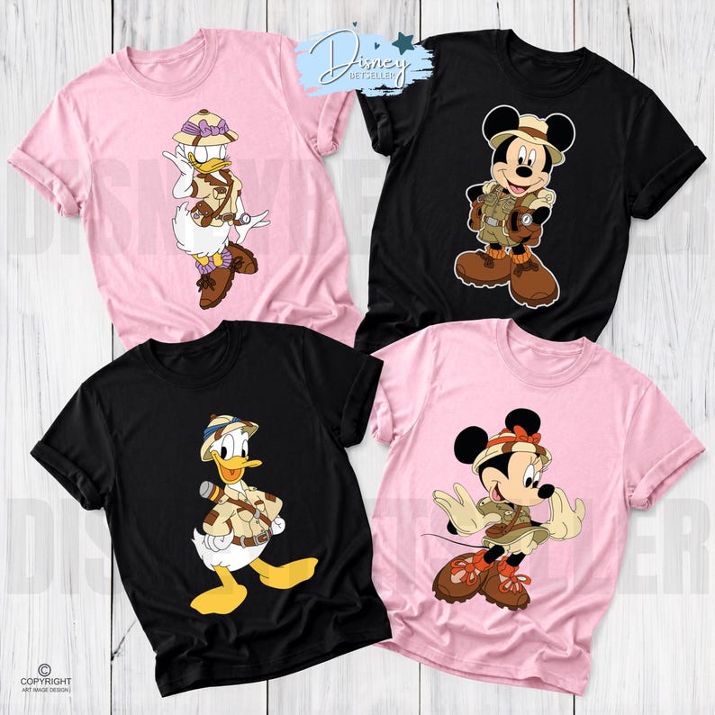 May include: Four short-sleeve crew neck t-shirts in black and light pink. Each shirt features a graphic print of a Disney character dressed in safari gear, including a pith helmet, khaki vest, and brown boots. The characters are Daisy Duck, Mickey Mouse, Donald Duck, and Minnie Mouse.