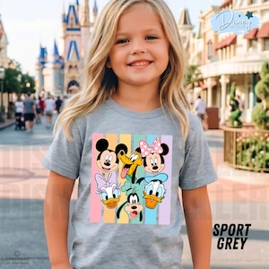 May include: A light gray t-shirt featuring a colorful graphic of Disney characters, including Mickey Mouse, Minnie Mouse, Donald Duck, and Pluto. The shirt has vertical pastel stripes and the words "SPORT GREY" are printed on the bottom right.