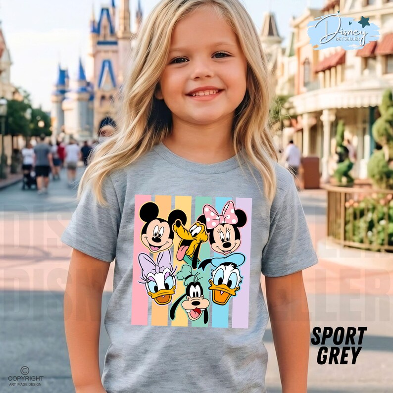 May include: A light gray t-shirt featuring a colorful graphic of Disney characters, including Mickey Mouse, Minnie Mouse, Donald Duck, and Pluto. The shirt has vertical pastel stripes and the words "SPORT GREY" are printed on the bottom right.