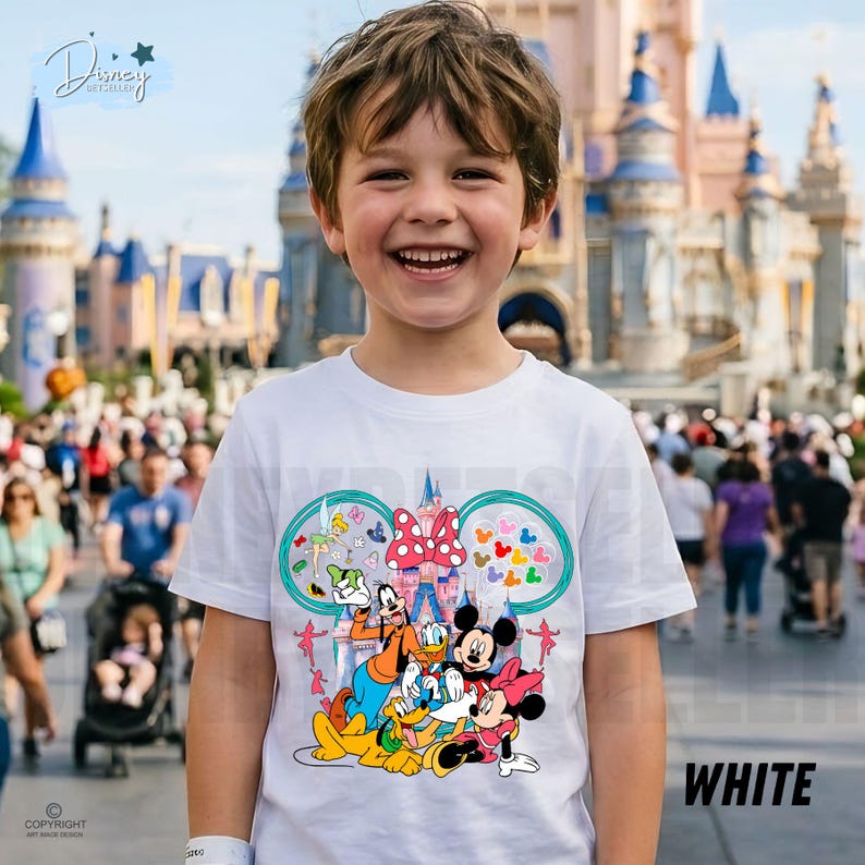 May include: A white t-shirt with a vibrant Disney character design, including Mickey and Minnie Mouse, Goofy, and Donald Duck. The shirt features a castle design and the word "WHITE" is printed on the bottom right.