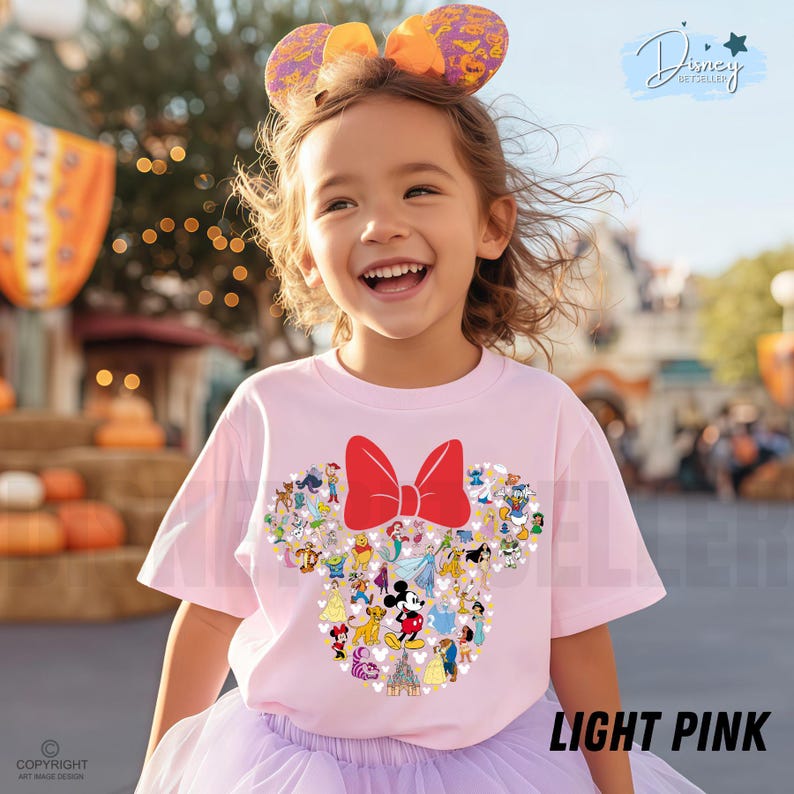 May include: A light pink t-shirt featuring a Minnie Mouse design with a red bow and various Disney characters. The shirt is worn by a smiling child. The text "LIGHT PINK" is visible at the bottom right.