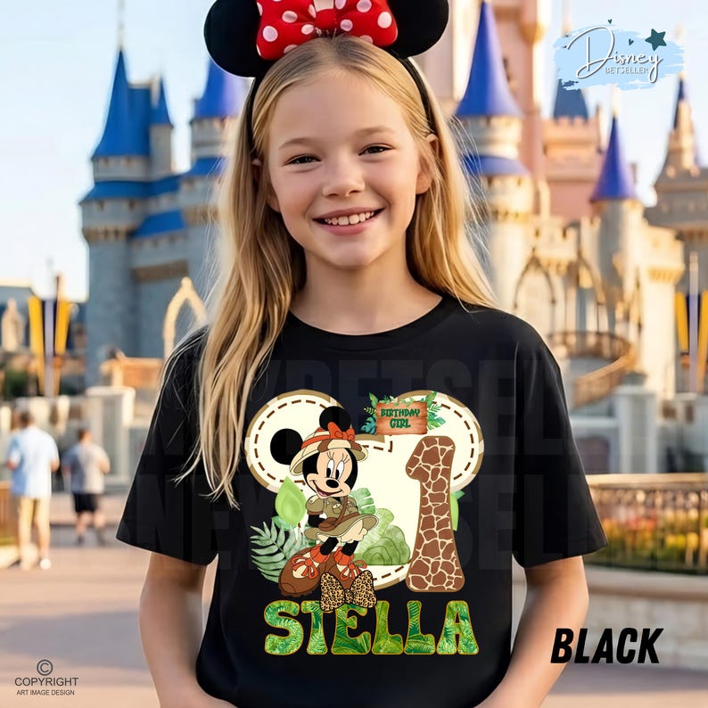 May include: Black t-shirt with a Minnie Mouse design, the text "Birthday Girl", and the name "Stella". The design includes a giraffe print number 1 and tropical foliage. The girl is wearing a Minnie Mouse ear headband.