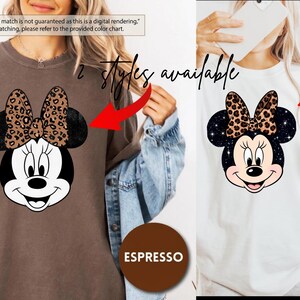 Leopard print Minnie Mouse head with sparkling galaxy-style black ears and a cheetah print bow, Disney-inspired graphic design on a transparent background. Cute Disney vacation shirt design for women, girls, and matching family trip tees