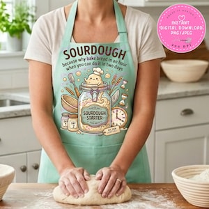 May include: A light green apron featuring a graphic of a sourdough starter jar with a smiling character, wheat stalks, a clock, and small jars labeled Day 1 and Day 2. The text reads SOURDOUGH because why bake bread in an hour when you can do it in two days.