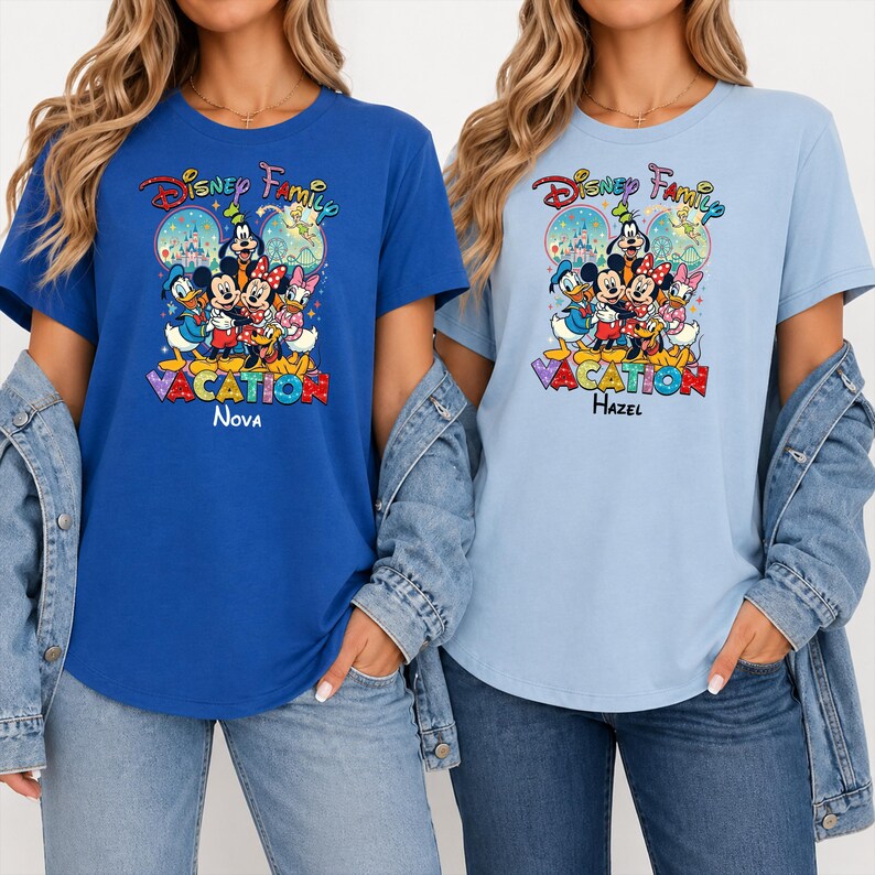 May include: Two short-sleeved t-shirts, one blue and one light blue, featuring a Disney Family Vacation graphic. The graphic includes Mickey Mouse, Minnie Mouse, Donald Duck, and other characters. The blue shirt says "Nova" and the light blue shirt says "Hazel".