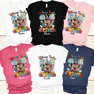 May include: A collection of Disney Family Vacation t-shirts in various colors, including white, black, pink, and navy. Each shirt features a colorful graphic of Disney characters and the text "VACATION" with a personalized name. The shirts are short-sleeved.