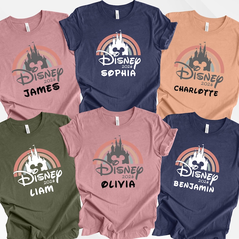 May include: Six short-sleeved t-shirts in different colours, each with a Disney castle design, a rainbow, and the text "Disney 2026" and a name. The colours are pink, navy, orange, green, and blue.