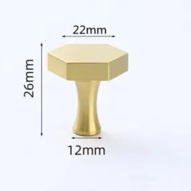 May include: A gold-colored hexagonal cabinet knob with a tapered base. The knob features a flat top measuring 22mm in width, a total height of 26mm, and a base diameter of 12mm, as indicated by the technical dimension lines shown in the image.