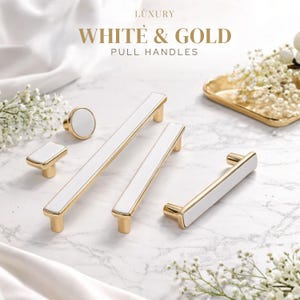 May include: A collection of luxury white and gold pull handles and knobs. The hardware features a polished gold metal finish with a smooth white inlay. The text LUXURY WHITE & GOLD PULL HANDLES is visible at the top of the image.
