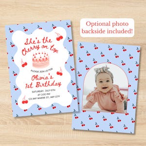 Op de afbeelding: Een lichtblauwe verjaardagsuitnodiging met een patroon van rode kersen, een illustratie van een taart en de tekst She's the Cherry on top, Olivia's 1st Birthday, Saturday, July 6th, at 2:00 PM, 123 Any Where St., Any City, met een fotokant.