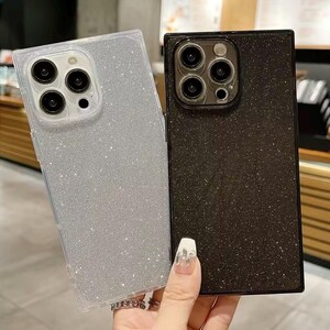 May include: Two glittery phone cases, one silver and one black, are displayed. The silver case has a clear border, while the black case has a black border. Both cases have a square design and feature multiple camera cutouts.