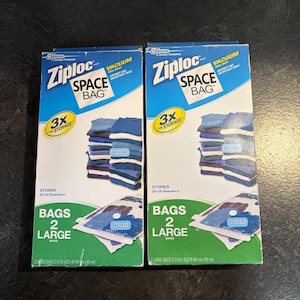 May include: Two identical Ziploc Space Bag vacuum seal bag boxes. Each blue and white box features a 3x the storage graphic, stores 20-24 sweaters, and contains 2 large bags measuring 21.5 inches by 33.5 inches with airtight and watertight seals.