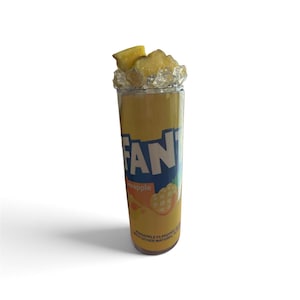May include: A tall cylindrical tumbler featuring a yellow and orange Fanta Pineapple soda label design. The top of the tumbler is decorated with realistic-looking faux pineapple chunks and clear acrylic ice cubes arranged around the rim.