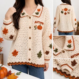 May include: A cream-coloured crochet cardigan featuring a collar, long sleeves, and a button-down front. The garment is decorated with embroidered autumn leaves and pumpkins, with the word "AUTUMN" stitched on the chest and a scalloped hem.