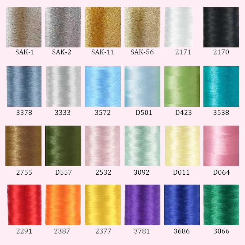 May include: A grid of twenty-four cylindrical spools of embroidery thread in various colours, including metallic gold, silver, black, white, red, blue, green, yellow, and pink. Each spool is labelled with a unique alphanumeric code below it.