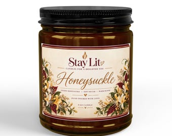 May include: A 9 oz candle in a clear glass jar with a black lid. The label features the text Stay Lit, Honeysuckle, Golden Honeysuckle, Soft Nectar, Warm Bloom, and Hand Poured With Love, decorated with illustrations of yellow honeysuckle flowers.