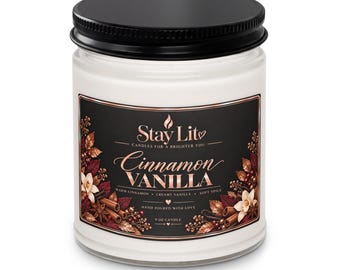May include: A 9 oz candle in a clear glass jar with a black metal lid. The label features a black background with rose gold text reading Stay Lit, Cinnamon Vanilla, Warm Cinnamon, Creamy Vanilla, Soft Spice, and Hand Poured With Love.