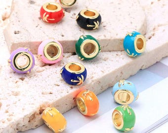 May include: A collection of small, round, metal beads featuring a gold-tone core and a colorful enamel coating. Each bead is decorated with a delicate, gold-colored palm tree motif. The set includes beads in red, black, pink, green, blue, orange, and yellow.