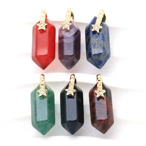 May include: Six hexagonal gemstone pendants in red, purple, blue, green, black, and brown, each topped with a gold-toned metal bail featuring a small star shape and a clear inset stone. The pendants are arranged in two rows of three items each.