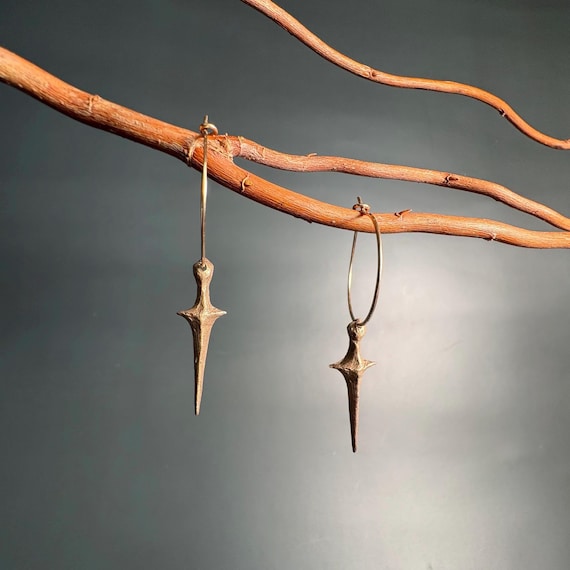 Bronze dagger and gold hoop earrings