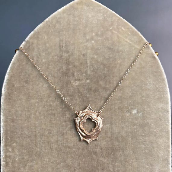 Little Portal necklace in bronze with gold chain