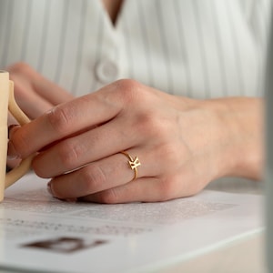 Custom initial ring worn on hand featuring a dainty ring for everyday jewelry wear