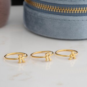 Script initial rings displayed together showcasing custom initial ring designs with minimalist ring styling