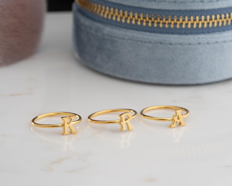 Script initial rings displayed together showcasing custom initial ring designs with minimalist ring styling