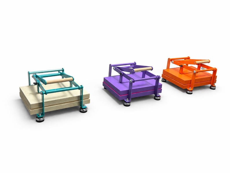 May include: Three colorful, wooden book presses. One is teal with a light wood handle, another is purple, and the third is orange. Each press has a wooden handle and sits on four small, round feet. The presses are on a white background.