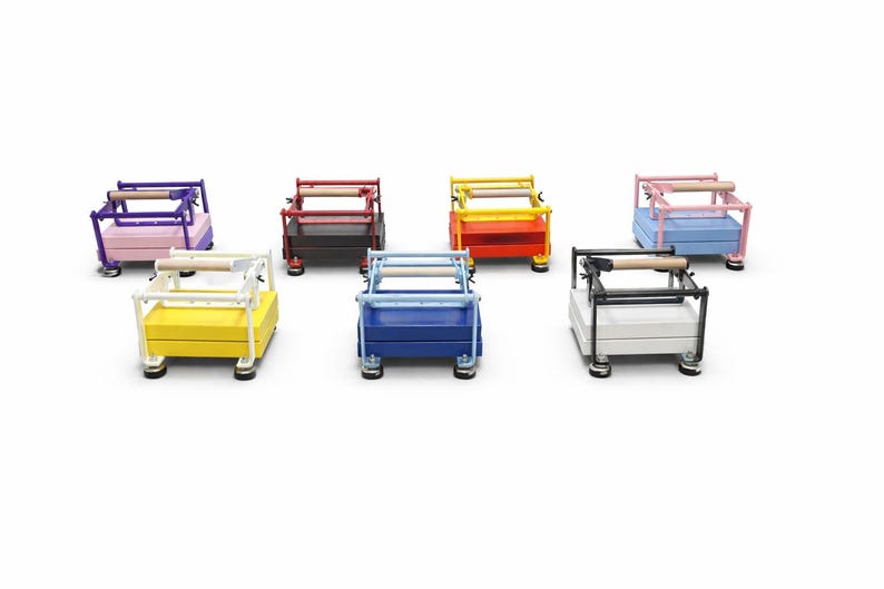 May include: A collection of colorful, miniature rolling carts. Each cart features a rectangular base and a wooden handle. The carts are painted in various colors, including purple, red, yellow, blue, pink, black, and white.