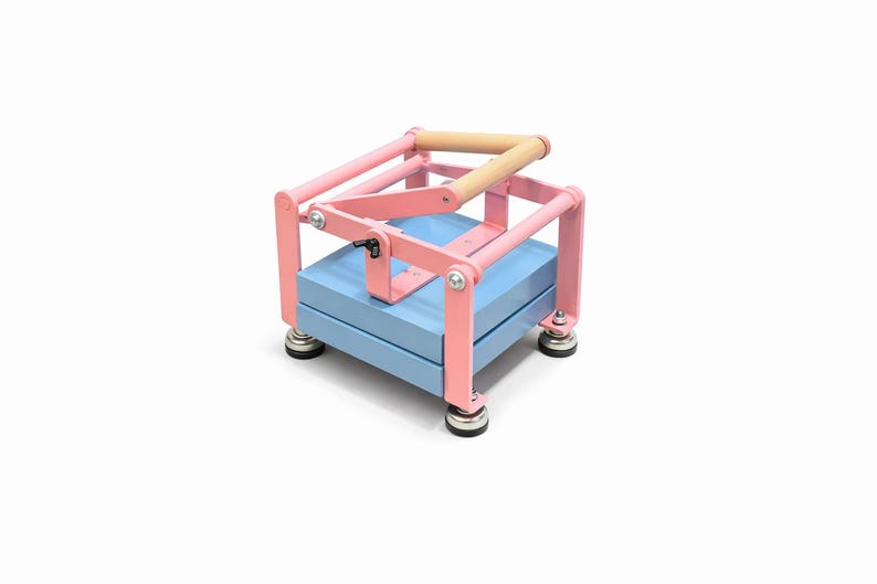 May include: A pink and blue press with a wooden handle. The press has a light blue base and pink metal frame. The handle is made of light-colored wood. The press sits on four small, round feet.