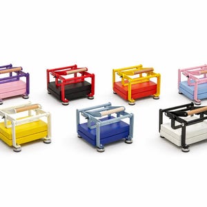 May include: A collection of colorful, miniature presses. Each press features a rectangular base and a frame with a wooden handle. The presses are in various colors, including purple, red, yellow, pink, white, blue, and black.