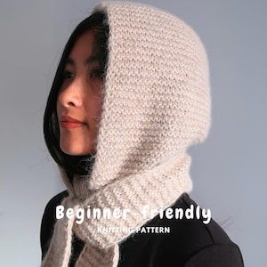 May include: A beige knitted hood with an integrated scarf, featuring a textured stitch pattern. The text "Beginner-friendly KNITTING PATTERN" is overlaid on the image. The hood covers the head and wraps around the neck with two long ends.