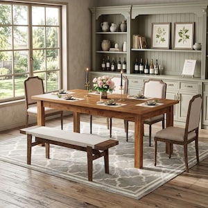 May include: A dining room set with a large wooden table, six upholstered chairs, and a bench. The table is set with placemats and a floral centerpiece. A patterned rug and a hutch with decor complete the scene.