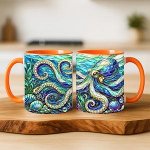May include: Two ceramic mugs with bright orange handles and rims, featuring a vibrant, stained-glass style illustration of an octopus swimming among seaweed, coral, and seashells in deep blue and green ocean waters with shimmering bubbles.