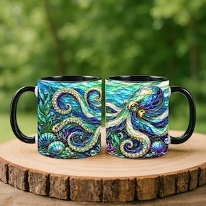 May include: Two ceramic mugs with black handles and rims, featuring a vibrant stained-glass style illustration of an octopus surrounded by seaweed, coral, and seashells in shades of deep blue, turquoise, and gold against a dark background.