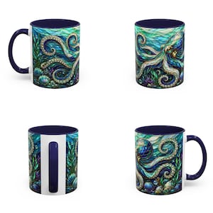 May include: A ceramic mug featuring a vibrant, stained-glass style illustration of an octopus surrounded by seaweed and seashells in shades of deep blue, teal, and green. The mug has a solid dark blue handle and a matching dark blue interior rim.