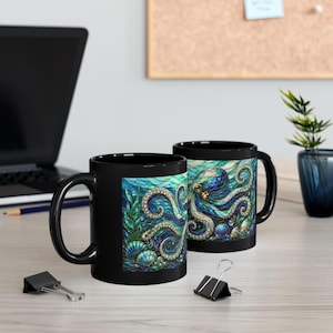 May include: Two black ceramic mugs featuring a vibrant, stained-glass style illustration of an octopus surrounded by seaweed and seashells in shades of blue, teal, and purple. The design wraps around the exterior of the mugs, showcasing intricate patterns and textures within the aquatic scene.