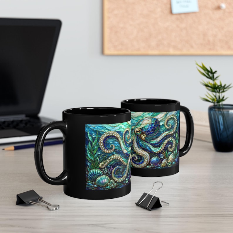 May include: Two black ceramic mugs featuring a vibrant, stained-glass style illustration of an octopus surrounded by seaweed and seashells in shades of blue, teal, and purple. The design wraps around the exterior of the mugs, showcasing intricate patterns and textures within the aquatic scene.