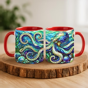 May include: Two ceramic mugs with bright red handles and interiors, featuring a vibrant, stained-glass style illustration of an octopus swimming among blue and green ocean waves, seaweed, and seashells with intricate golden detailing.