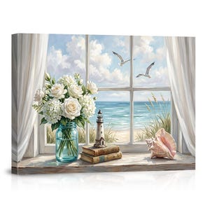 May include: A canvas print depicting a window view of the ocean with two seagulls flying in a cloudy sky. On the windowsill sits a blue glass mason jar filled with white roses and hydrangeas, two stacked books, a lighthouse figurine, and a seashell.