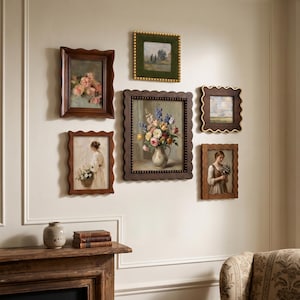 May include: A gallery wall arrangement featuring six framed artworks with scalloped edges. The collection includes paintings of floral bouquets in vases, landscapes, and figures in period clothing, displayed in dark wood and green velvet frames.