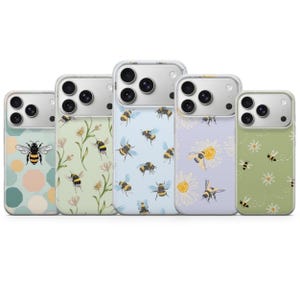 May include: Five smartphone cases arranged in a row, each featuring a unique bee and floral pattern. The designs include geometric shapes, botanical illustrations, and various bee motifs in soft pastel colors like light blue, green, and lavender.