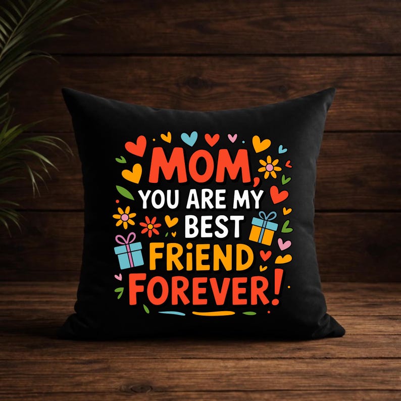 May include: A black square throw pillow featuring the colorful text MOM YOU ARE MY BEST FRIEND FOREVER! surrounded by various illustrations of small hearts, flowers, and two gift boxes in shades of orange, yellow, pink, light blue, and red.
