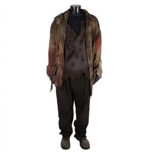 May include: A distressed ensemble featuring a brown, tattered long-sleeve jacket with frayed edges, layered over a dark brown, hole-riddled shirt. The outfit includes dark brown trousers and matching dark brown shoes, all presented on a mannequin.