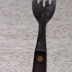 Stainless steel four tine fork with wood handle
