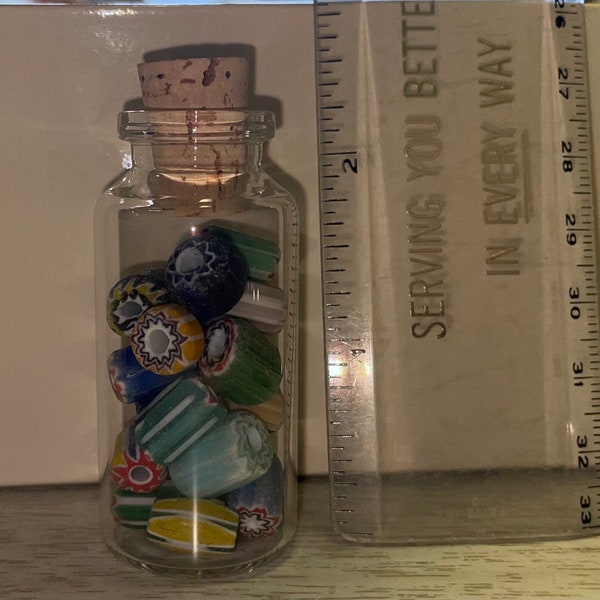 Small glass corked bottle with glass beads