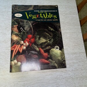 May include: Vintage "Good Housekeeping's Book of Vegetables" with a colorful cover featuring various vegetables. The cover text reads "Good Housekeeping's Book of Vegetables" and "to tempt the most reluctant appetites."