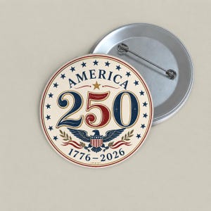 May include: A circular badge with the words "AMERICA 250" in navy and red, encircled by stars. An eagle emblem and the years 1776-2026 are also displayed. A second, plain silver badge is visible.