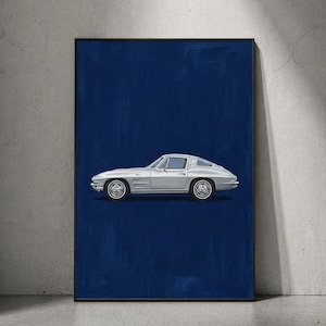 May include: A framed print depicting a silver classic car on a dark blue backdrop. The car, a coupe, is shown in profile. The artwork is presented in a black frame, offering a strong visual contrast. The print is suitable for a car enthusiast.